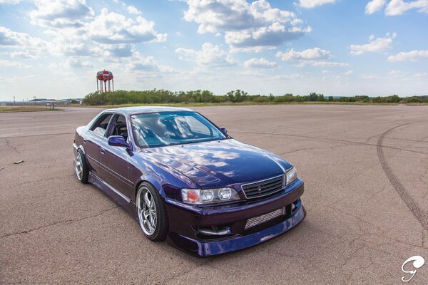 Blue toyota chaser on the asphalt field