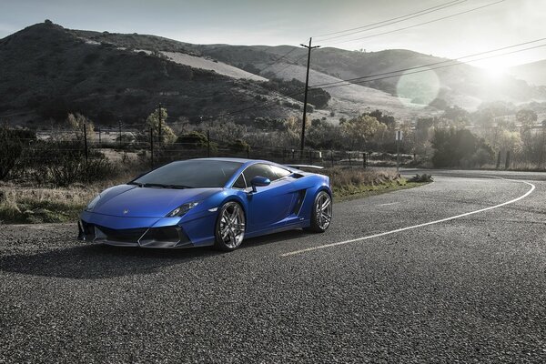 Glamorous blue lamborghini gallardo on the highway in Spain