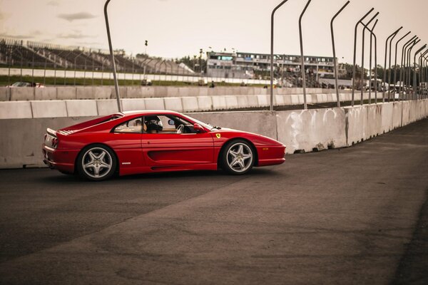 The classic Ferrari car is on the race track