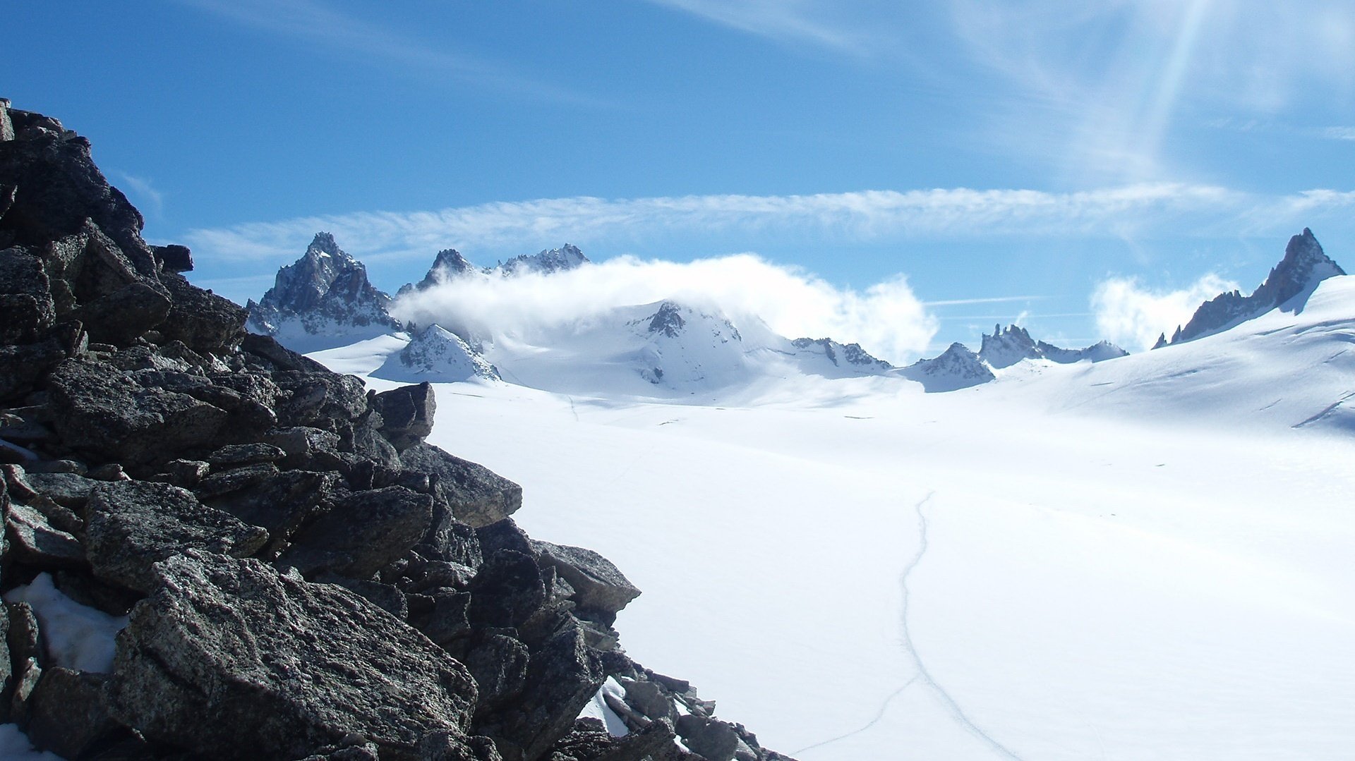 gray mountain stones snow carpets track mountains snow landscape the snow view frost the wind shroud cloud