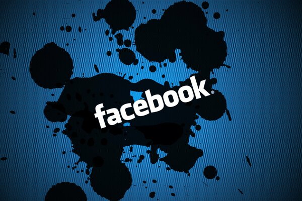 The logo of the social network facebook on the background of dark blots