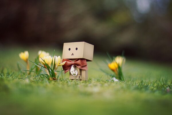 A cute creature made of boxes among flowers