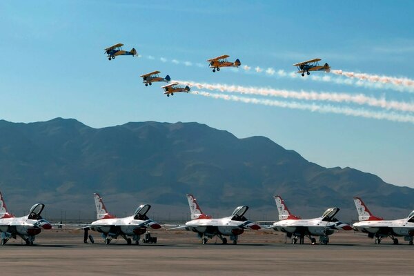 Airfield on the background of mountains with flying military fighters