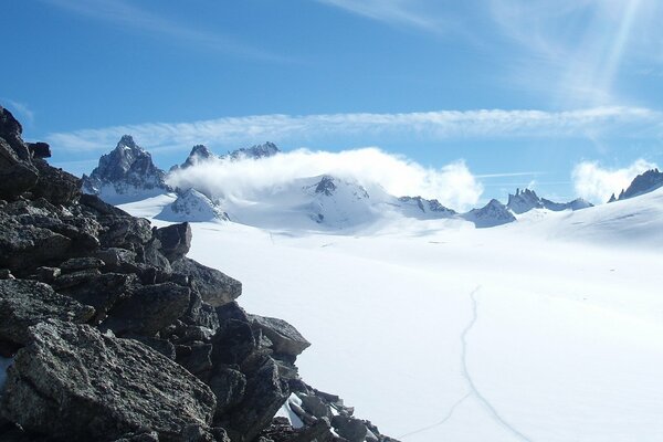 Piedras de montaña grises cubiertas de nieve