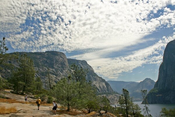 Tourists walk on the rocks, an extraordinary sky