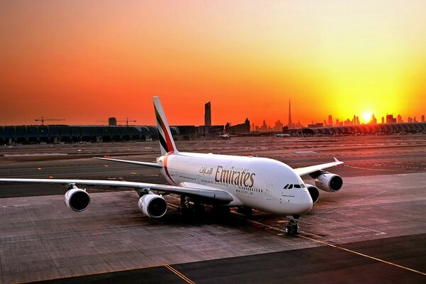 An airliner on the background of a beautiful sunset