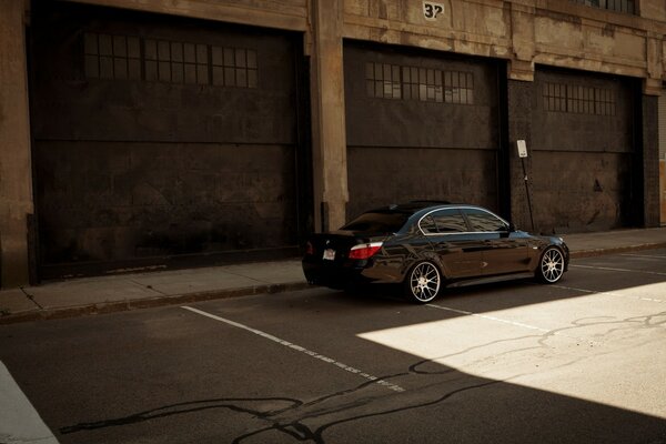 A black car on the background of a large gate