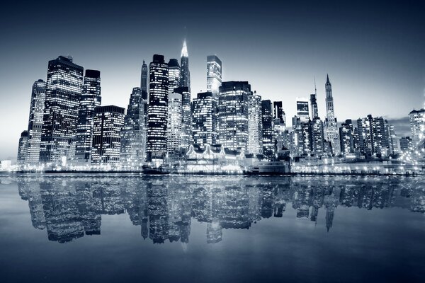 The glare of skyscrapers on the water