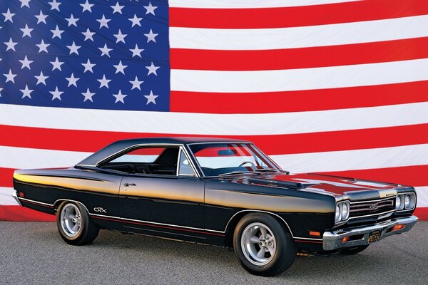 Black retro car on the background of the American flag