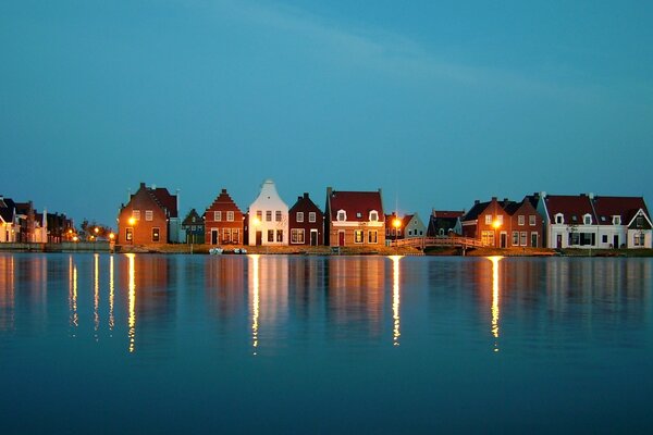 Reflections in the water from the windows of houses