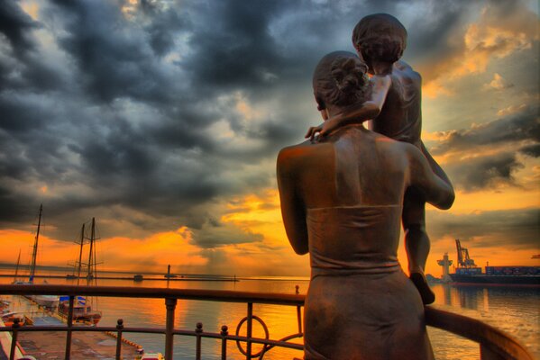 Monument of a welcoming woman with a father s child