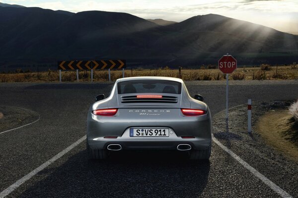 The trunk of a gray sports car