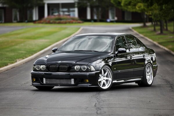 Black BMW e 39 on the road