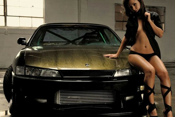 Beautiful supermodel posing with a nissan car