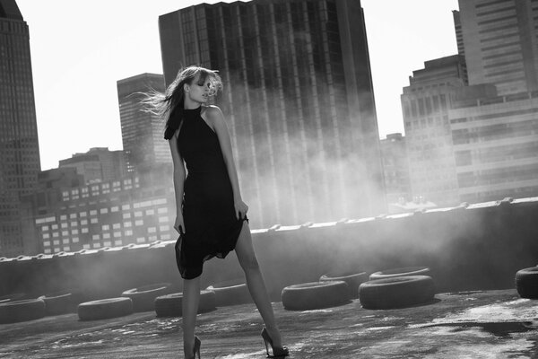 Girl on the roof with wheels in the city