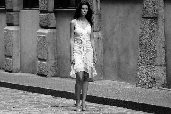 Black and white picture. A girl in a white dress