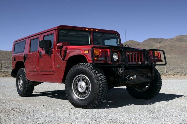 Brown SUV Hummer H1 jeep in the desert