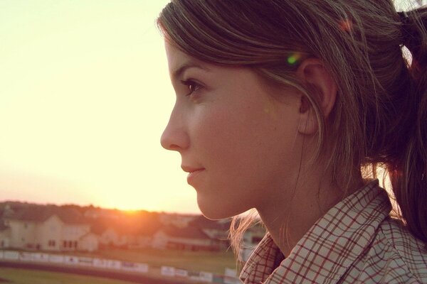 Fille de profil sur fond de coucher de soleil