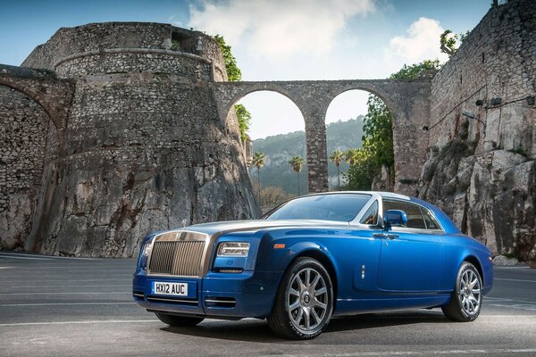 A powerful blue car on the background of old castles