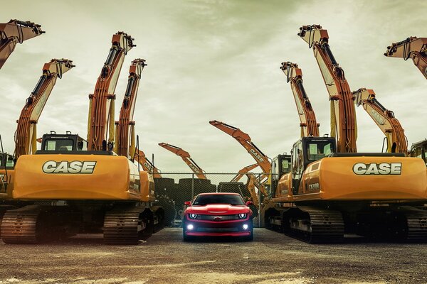 A powerful Chevrolet car surrounded by excavators