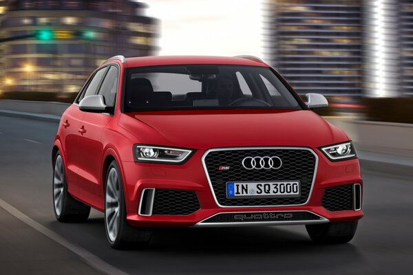 The red Audi is moving through the city