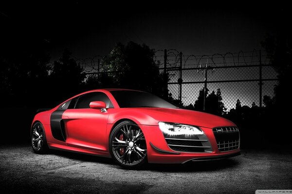 There was a red Audi R 8 on a black background