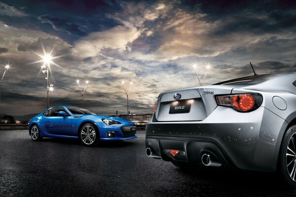 Blue and silver cars on a background of sparkling sky