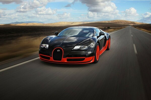 Bugatti veyron of red and black color rushes along the road
