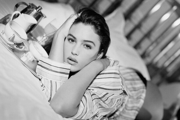 Monica Bellucci in bed with morning coffee on a tray