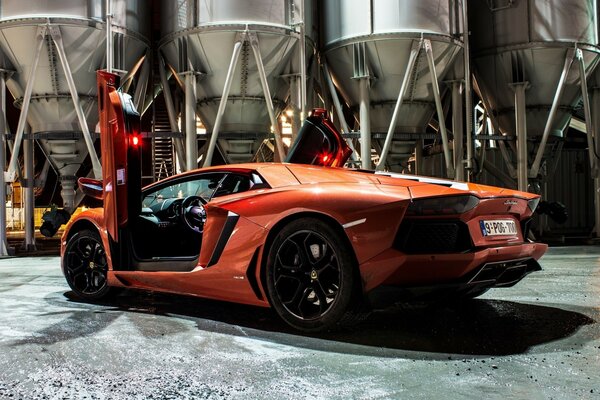 Orange Lamborghini aventador with open doors