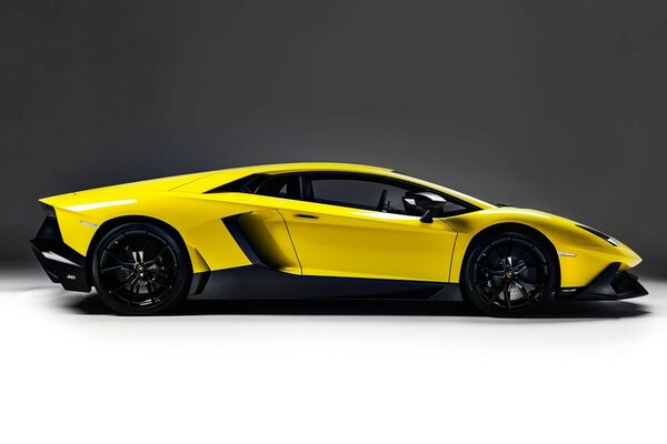 A sporty yellow car on a dark background