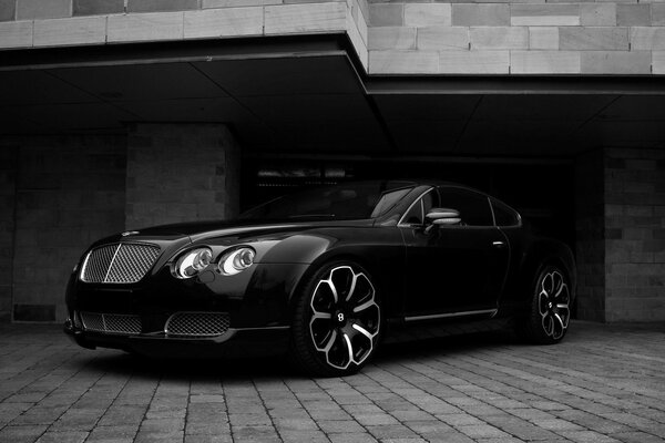 Black car with flower-shaped discs