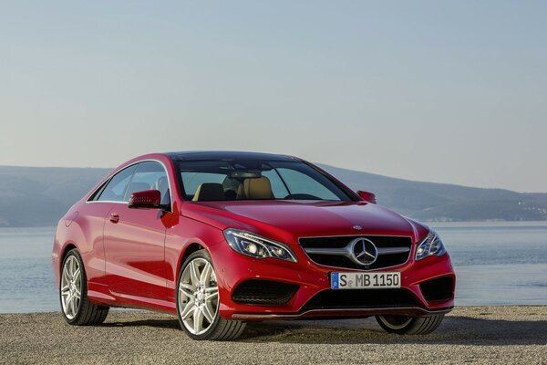 Red Mercedes Benz on the background of the sea