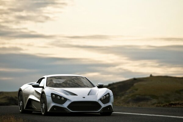 Sports car on the background of plains and hills