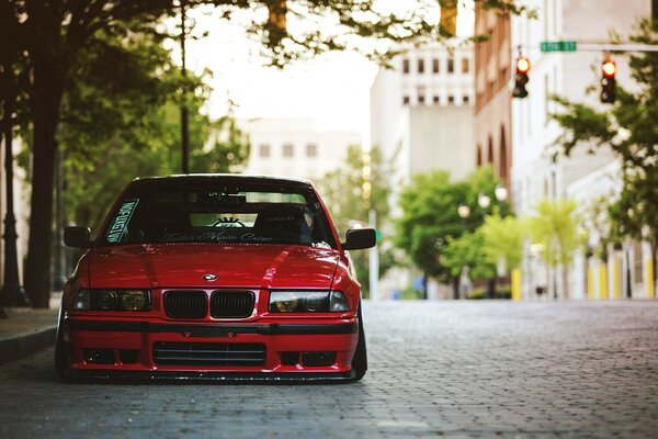 A burnt-out tuned red BMW car