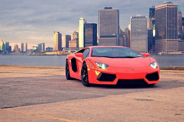 Supercar Rossa Lamborghini sullo sfondo di una grande città
