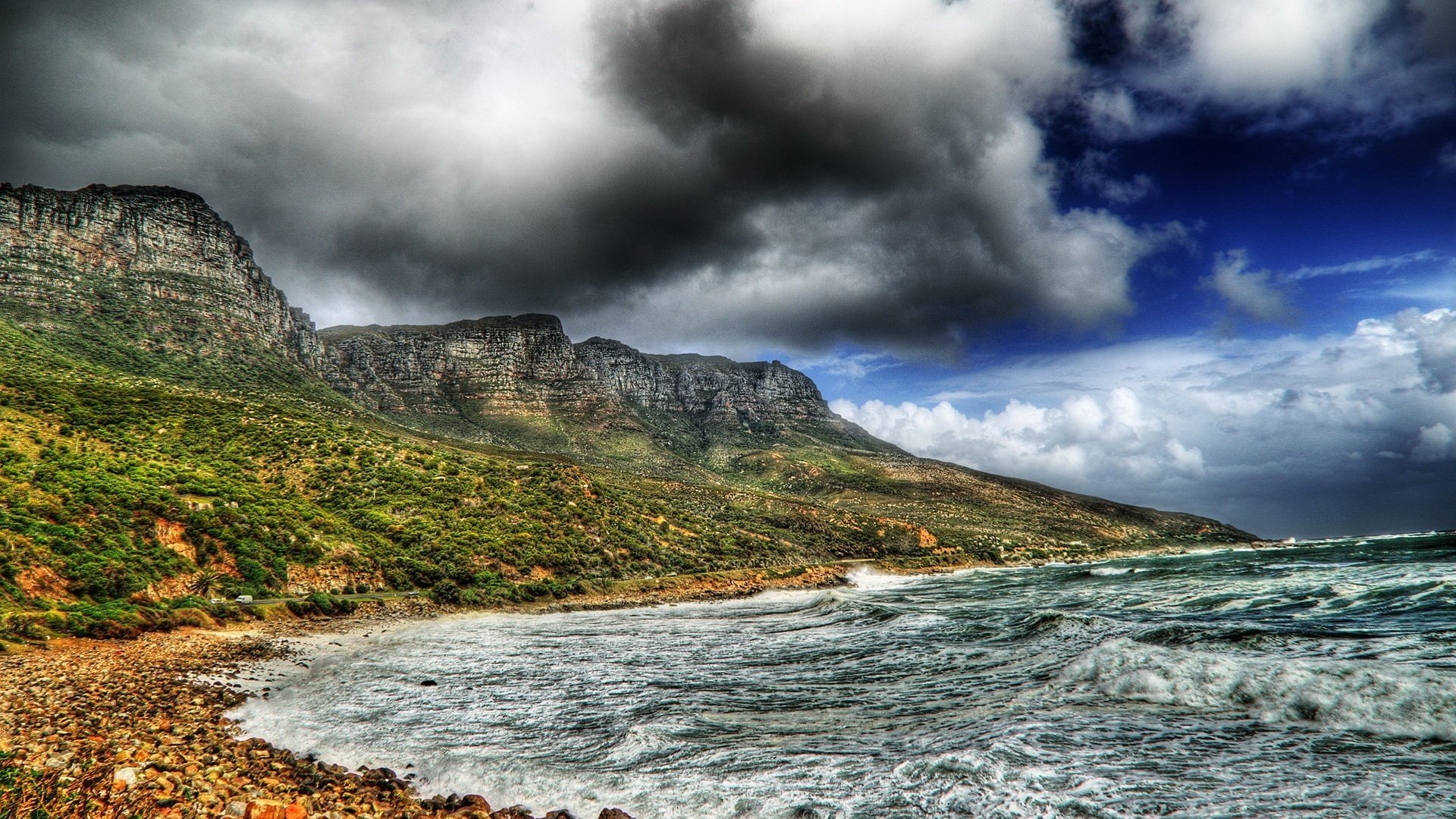 the storm dark clouds water waves the sky mountains river