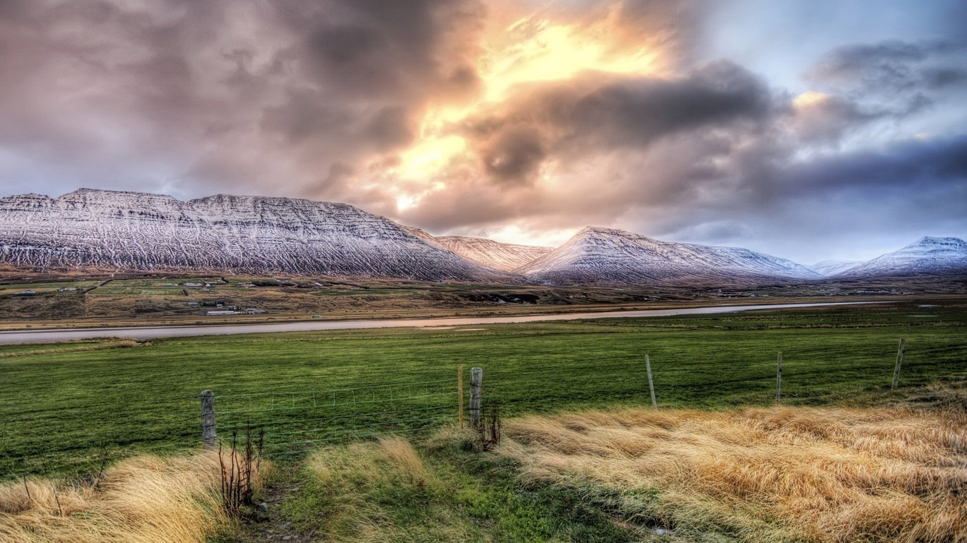 on the eve of the storm the wind makes the grass road the sky mountains field