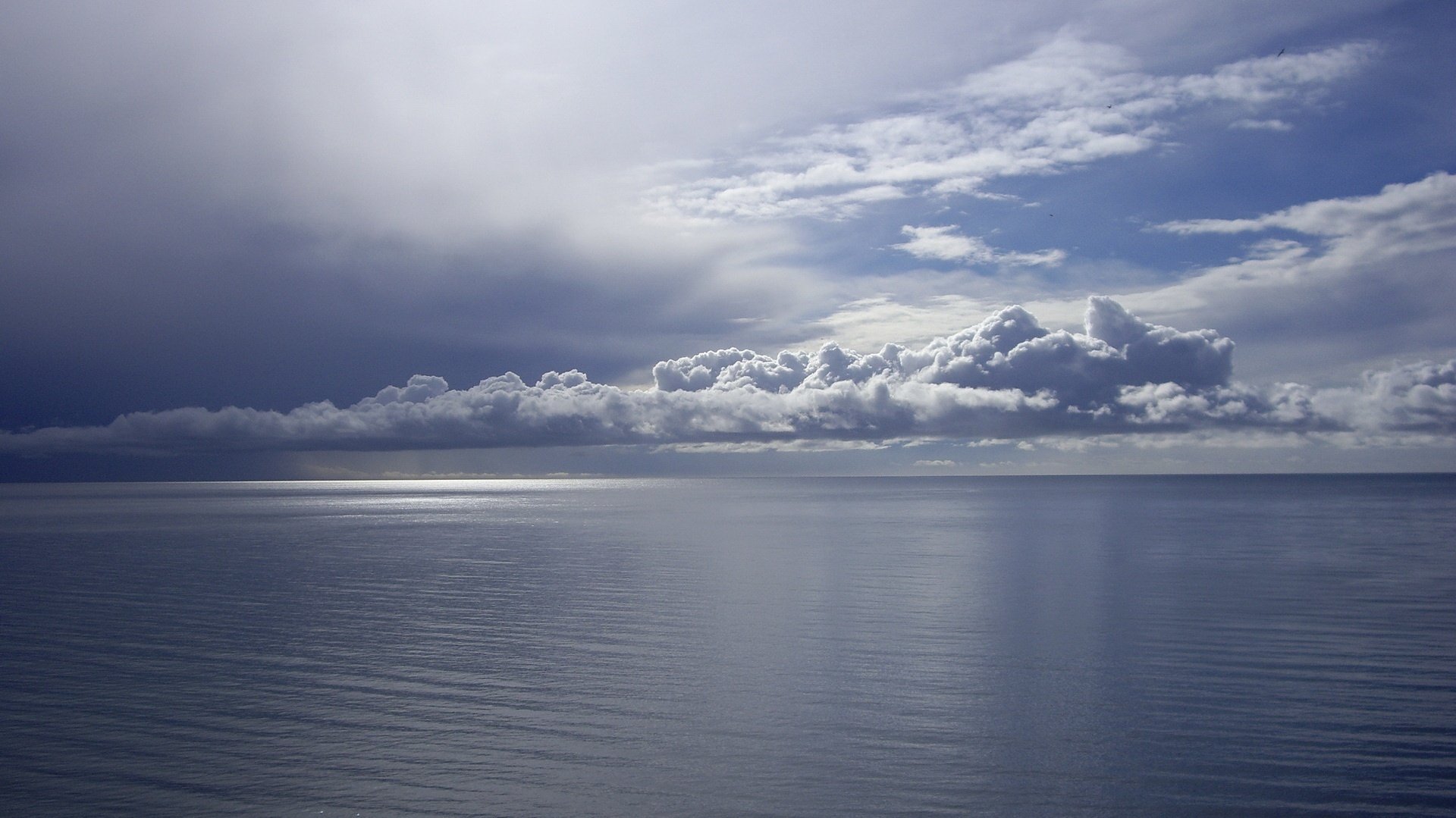 dark blue sky the reflection on the water rays of light the sky water surface horizon landscape sea calm silence cloud