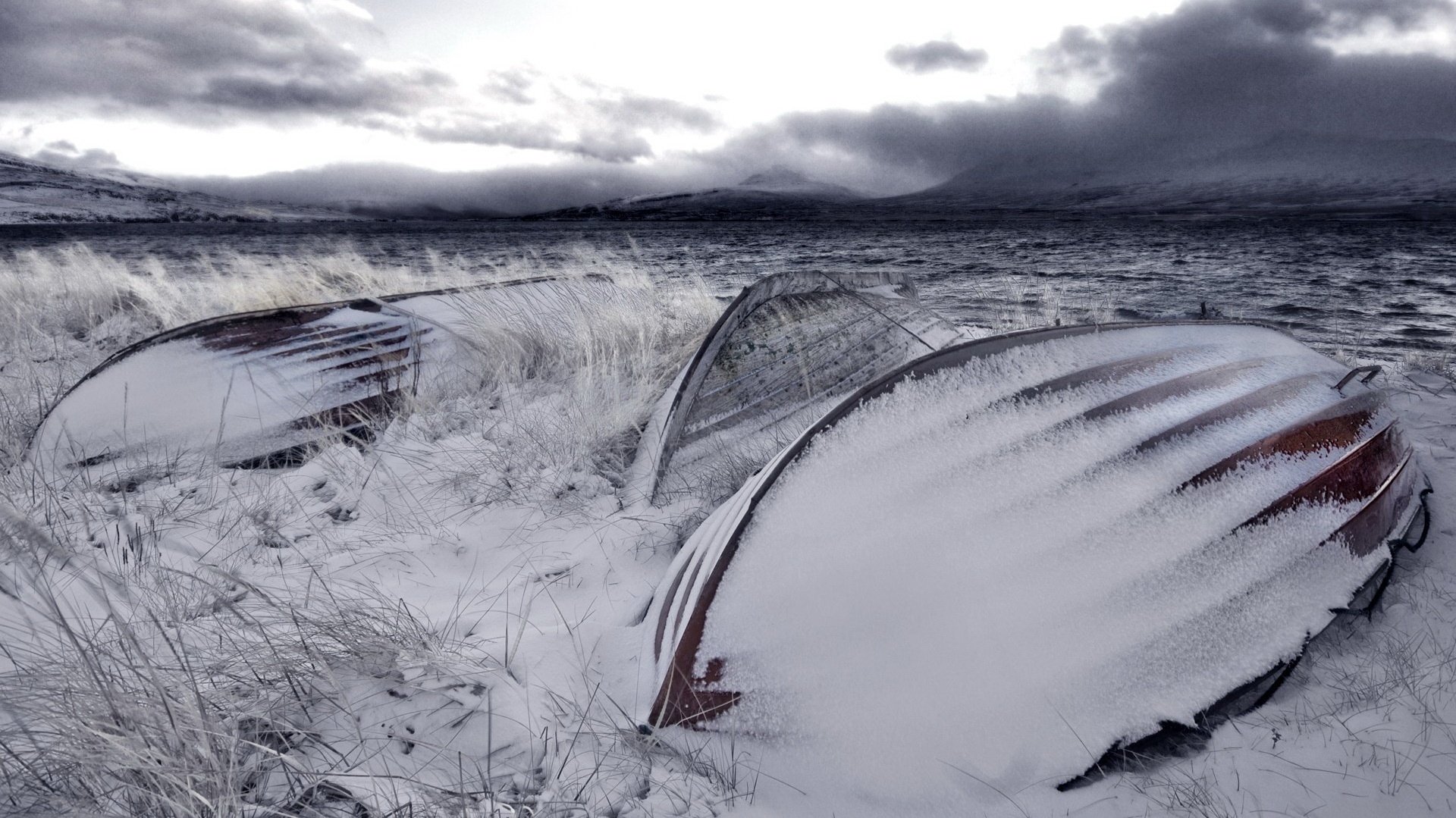 boat upside down snow veil dark clouds winter cold the evening frost the wind field