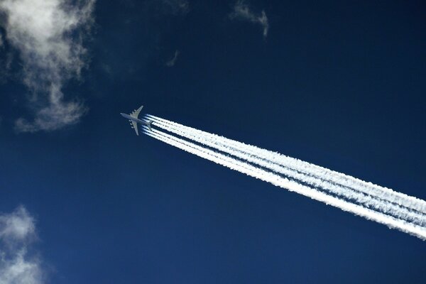 The trace on the blue sky of the flight of the AN-225 aircraft