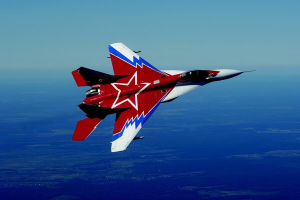 A multicolored fighter jet takes off high into the blue sky