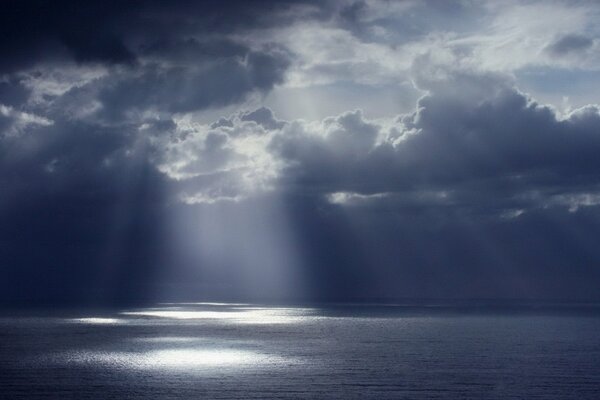 A glimmer of water over a clouded sky