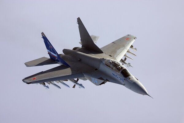 Flying MiG-35 aircraft on a purple sky background