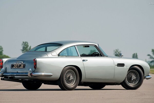 Grey classic car on an asphalt road