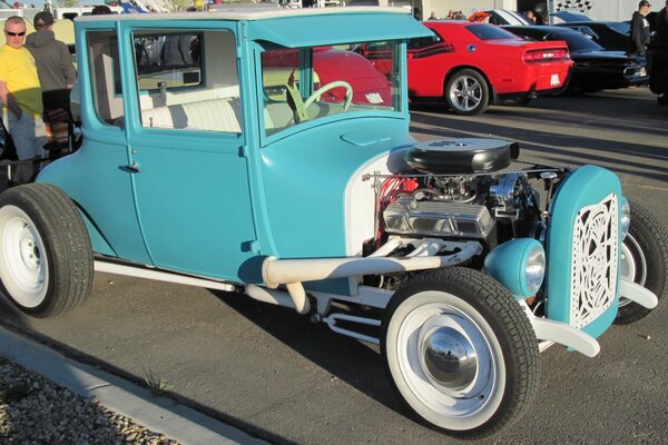 Photo of a classic blue Ford with an open engine