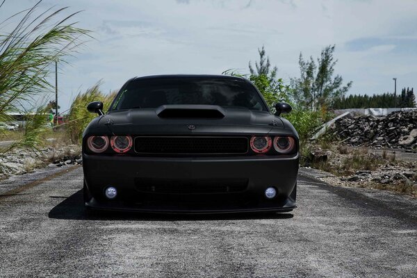 Car on the highway, black van red headlights