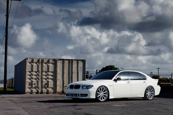 White car on the background of a container