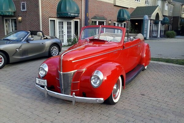 An old red car in the town