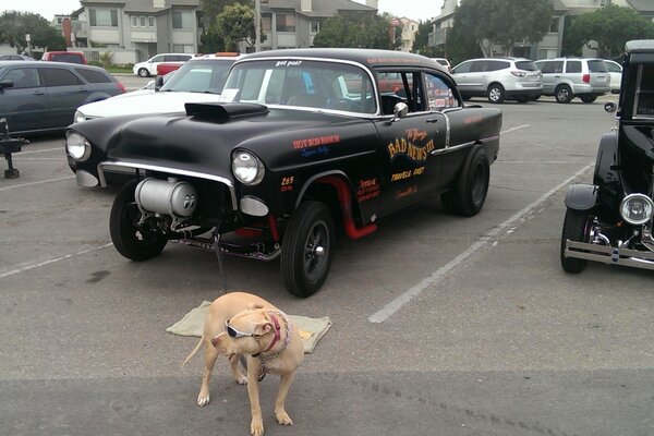 An old black tuned car in the parking lot